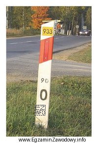 Liczba 933 na żółtym tle umieszczona na słupku prowadzącym 